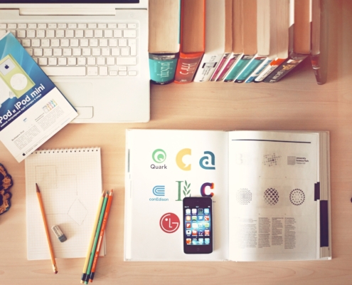 pencils and smartphone on top of books