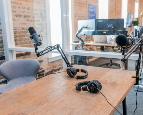 two black headphones on brown wooden table