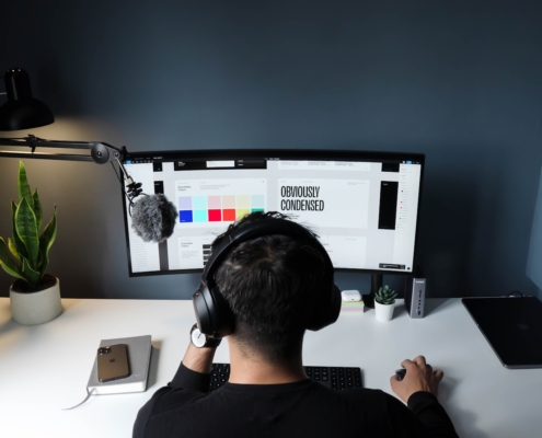 Freelancer in black shirt sitting in front of computer