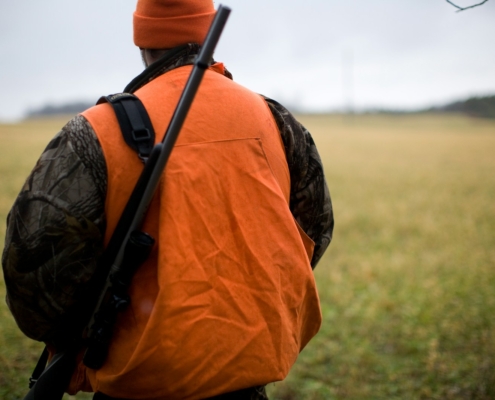 man in orange and black backpack