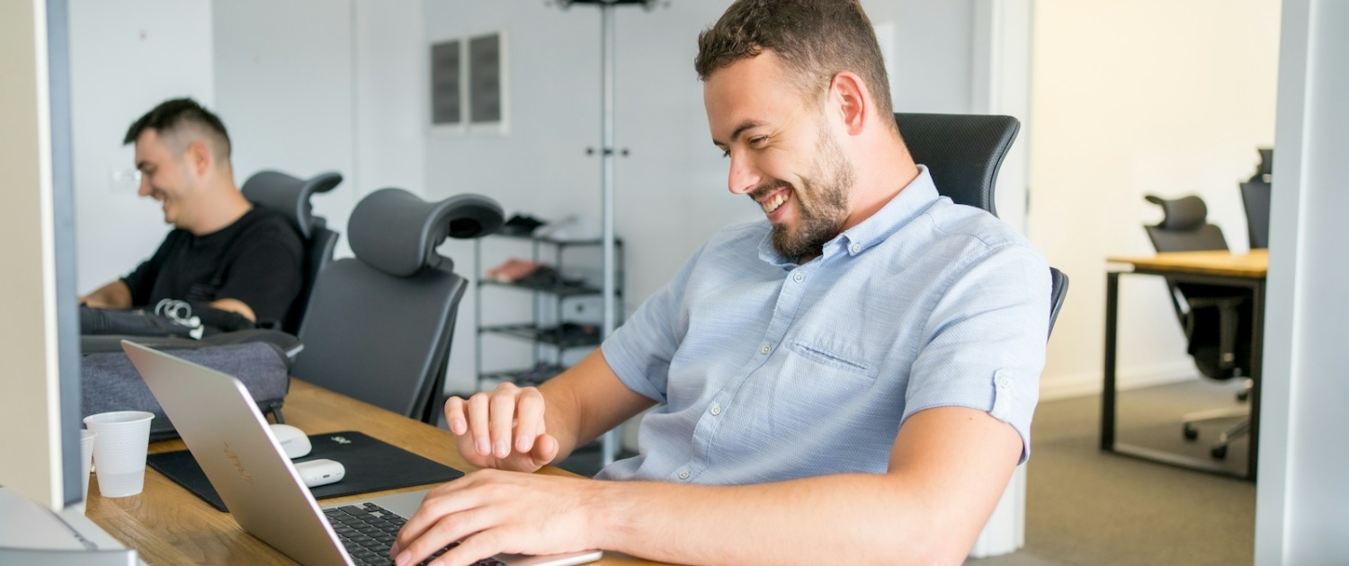 a man sitting in front of a laptop computer