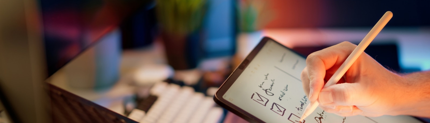 Someone is writing on a tablet with a stylus.