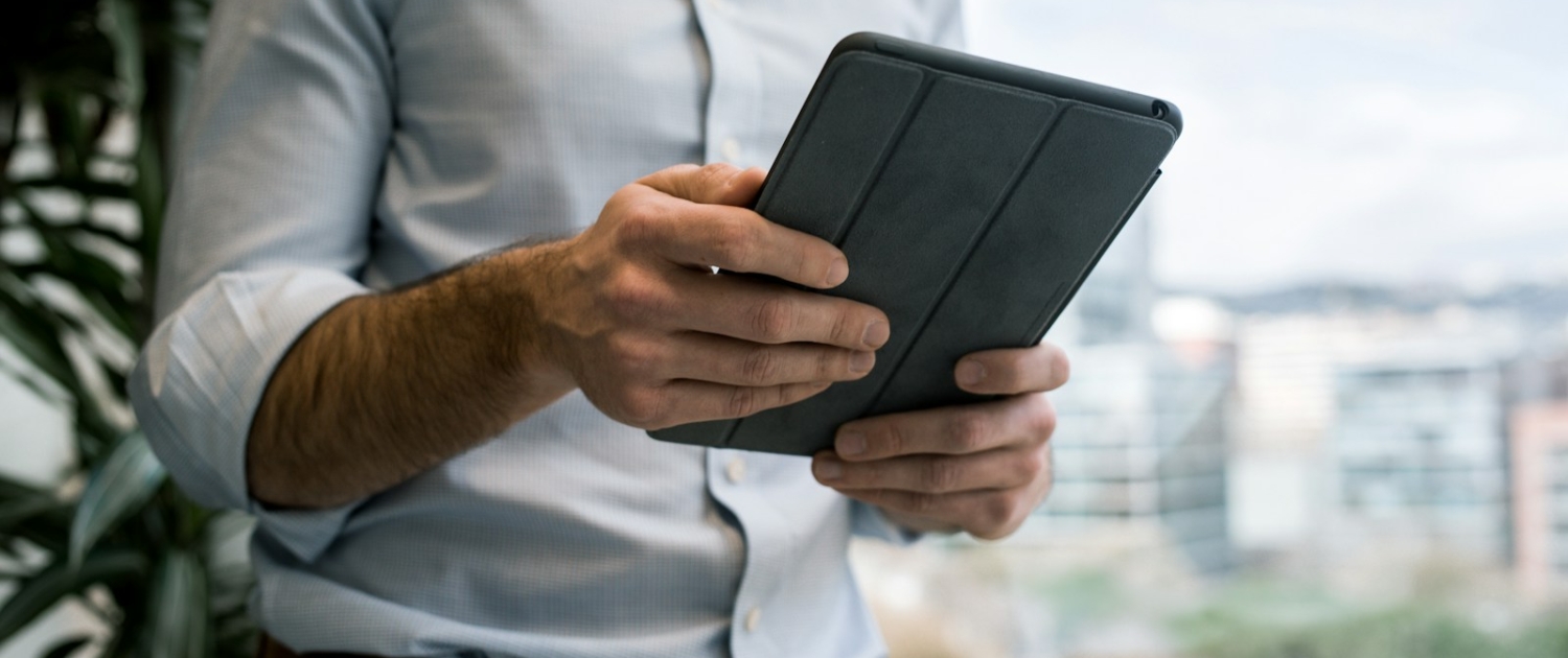 person holding black smart cover during daytime