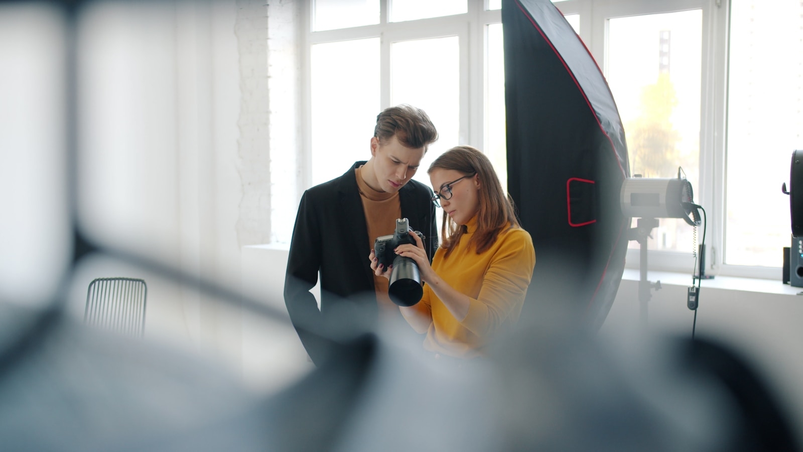 Two people looking at a camera in a studio.